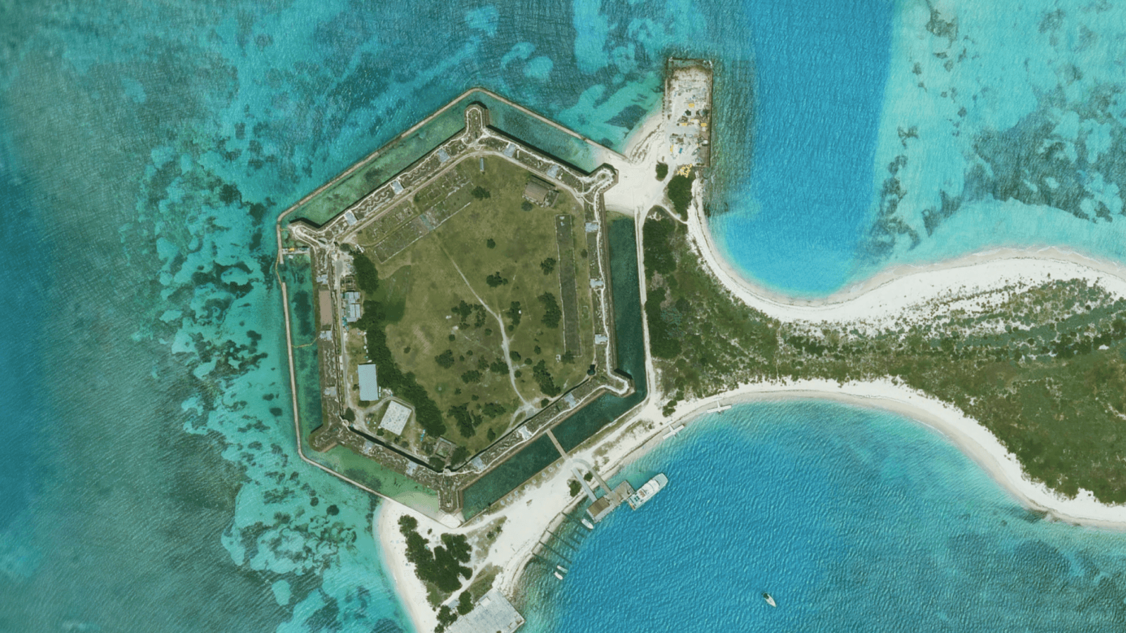 High-resolution aerial satellite view of Fort Jefferson in Florida surrounded by clear turquoise ocean water.